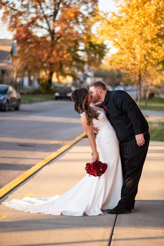 Bride and Groom Kissing on City sidewalk